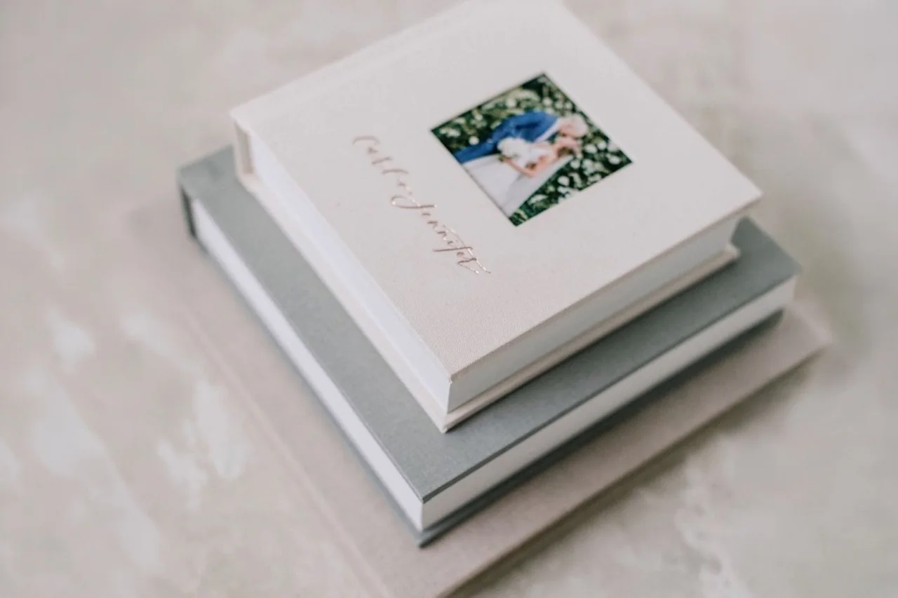A linen album cover with names foil-stamped and a cameo window