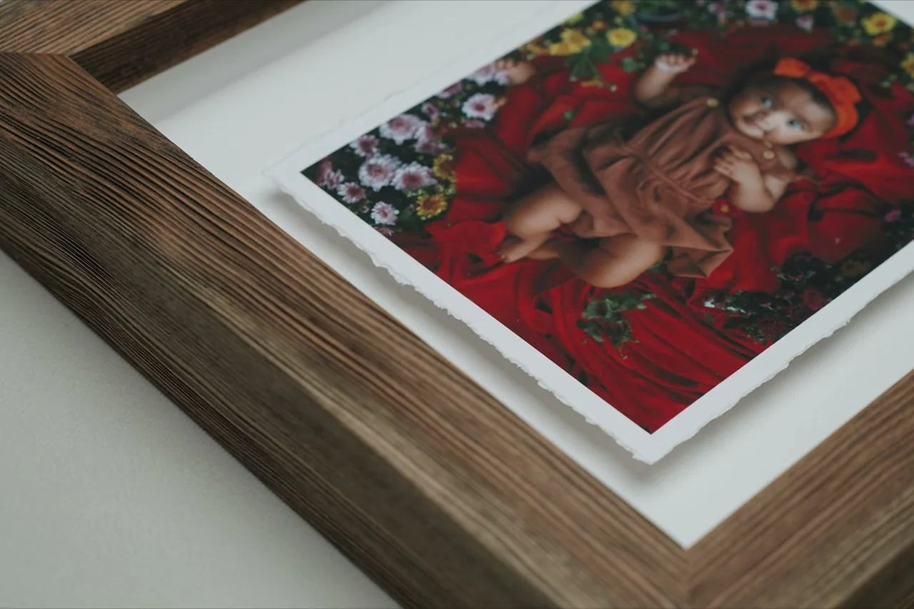 A hand-torn deckled print mounted inside a wide rustic wooden frame