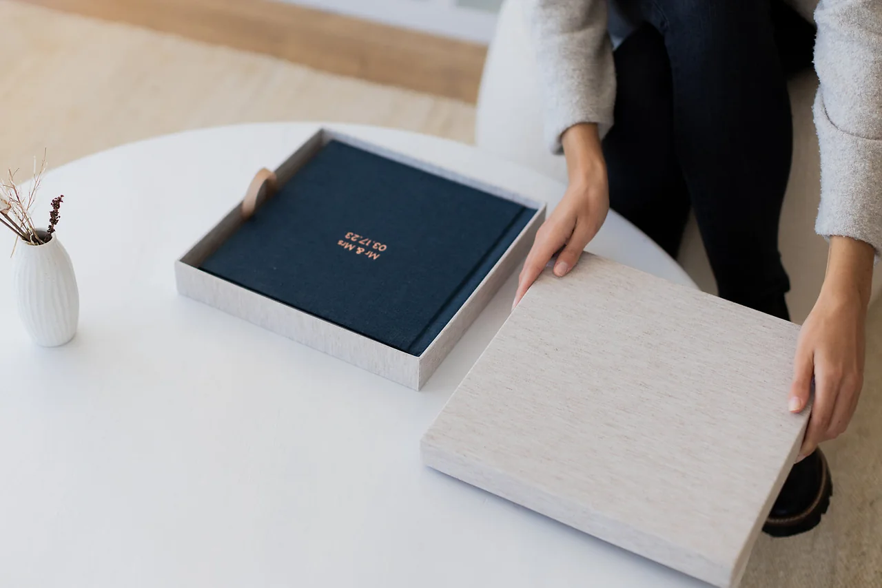 A stack of lay-flat photo books in linen covers