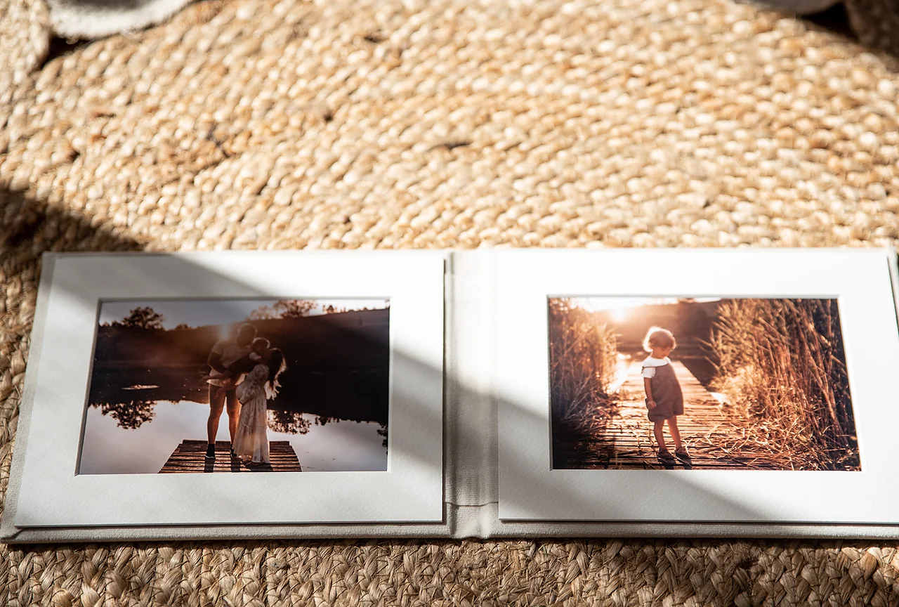 An open matted folio with prints held in archival mats