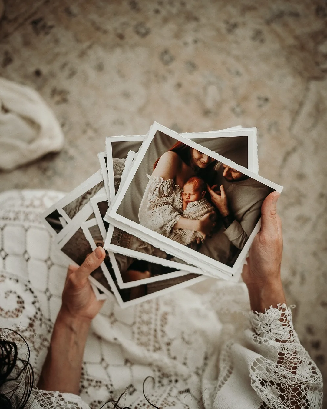 Photographic prints, fanned out in one hand