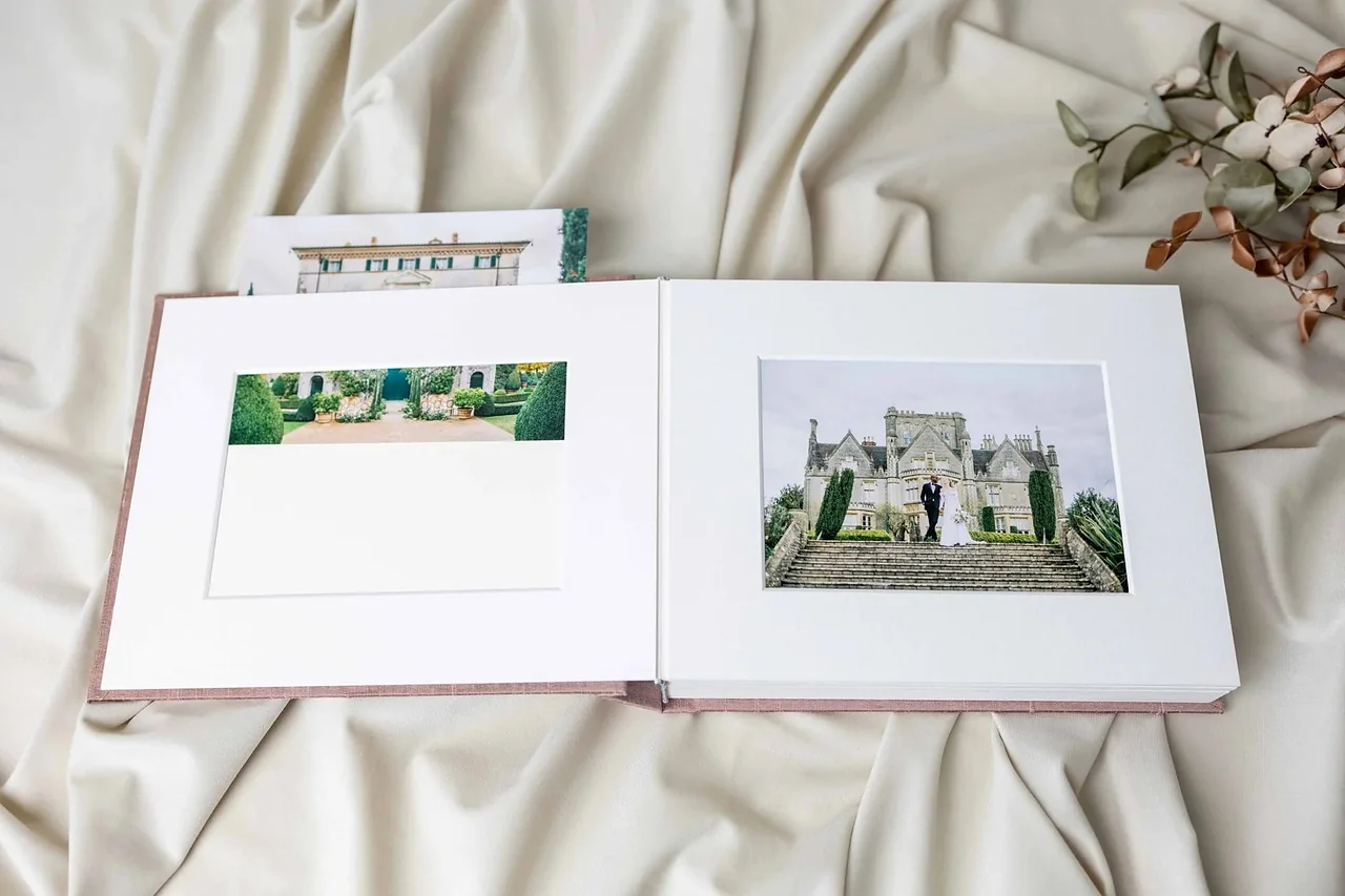 An open matted album showing a single photograph on each page